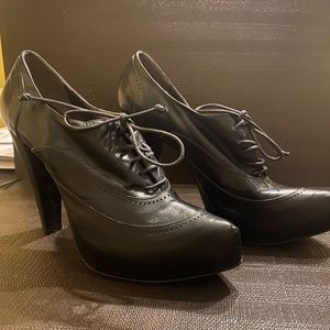 Black leather lace up Oxford heels. Never worn. Made in Italy